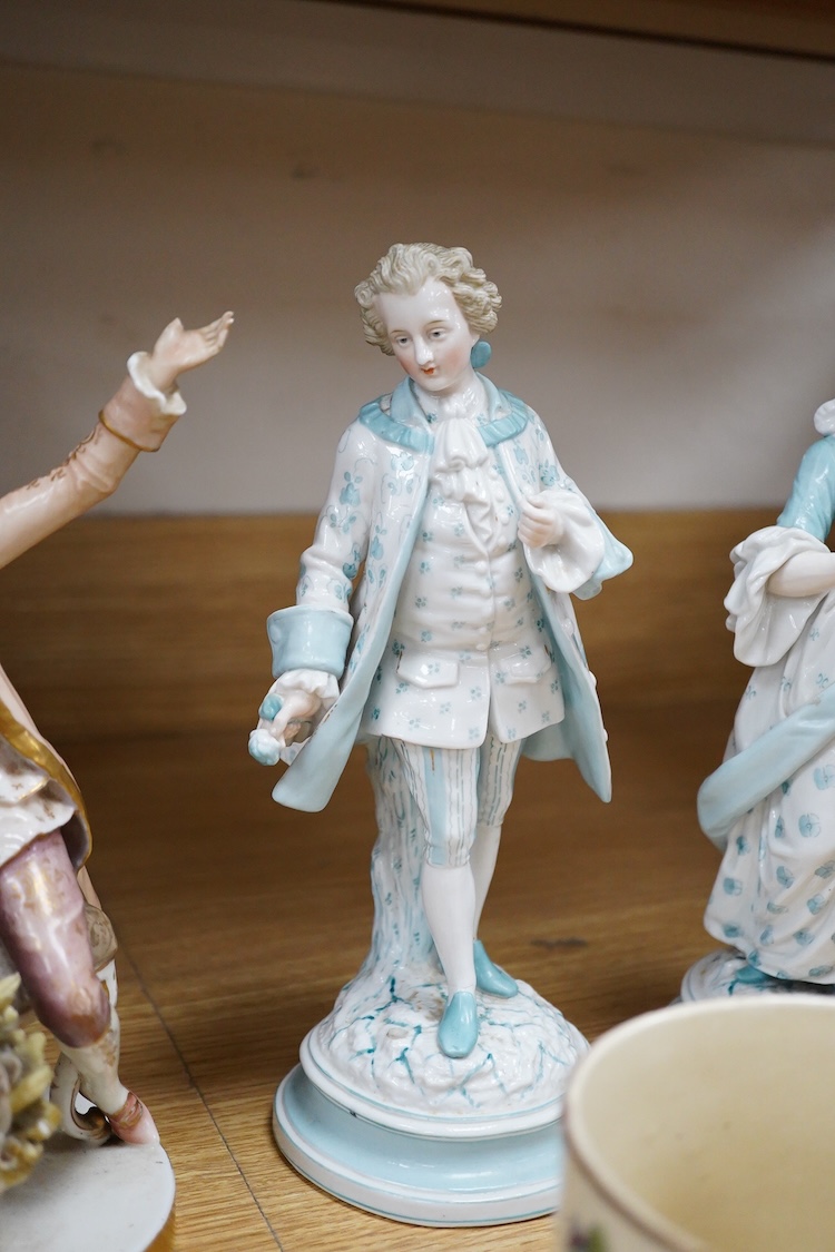 Sundry porcelain comprising three German figures, a Royal Worcester blush ivory ewer and a mug, together with a blue wine glass, largest 26cm high